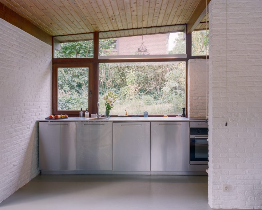 Kitchen with white brick walls and metal units