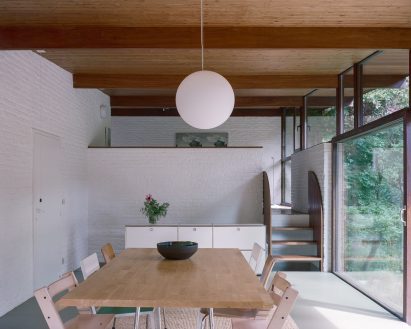 White dining room interior in a refurbished 1960s home