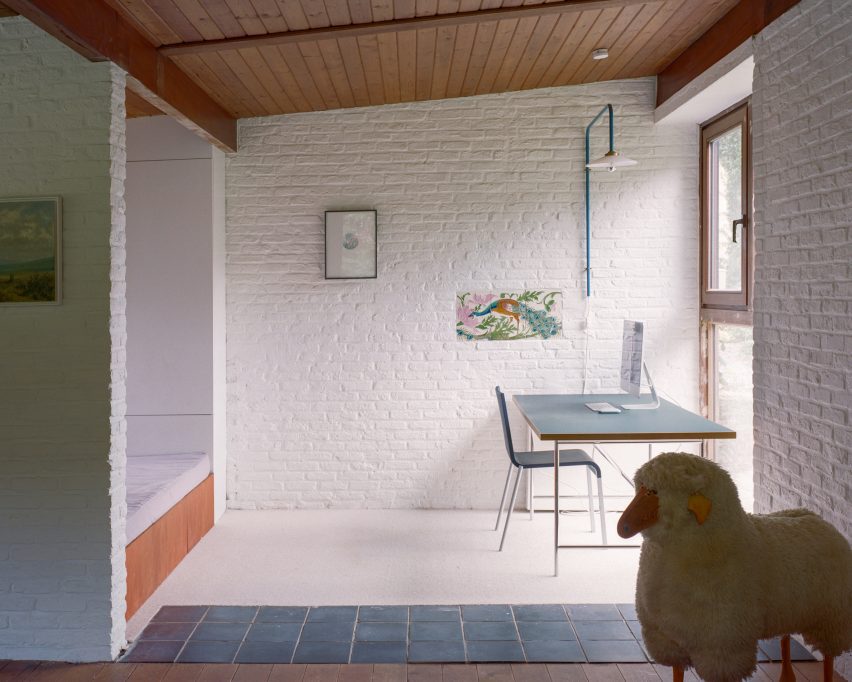 Study room with white brick walls and timber ceilings
