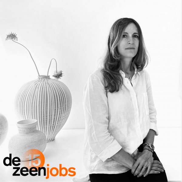 Black and white portrait of Elisa Vago with vases in the background