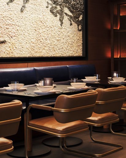 Dining tables between leather chairs and banquettes