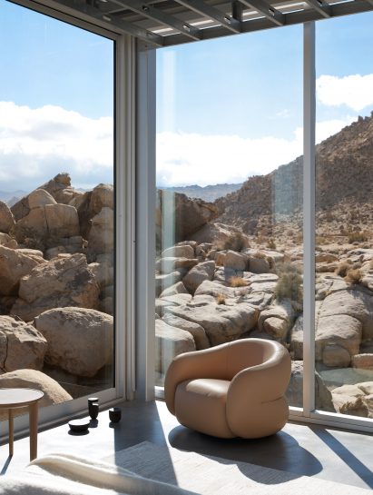 Brown swivel chair in corner of glazed room
