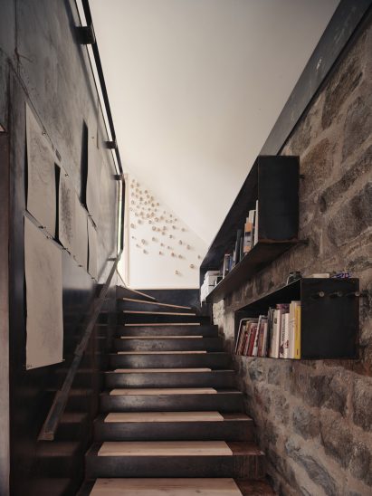 Steel stairs and interior details against original granite stone structure