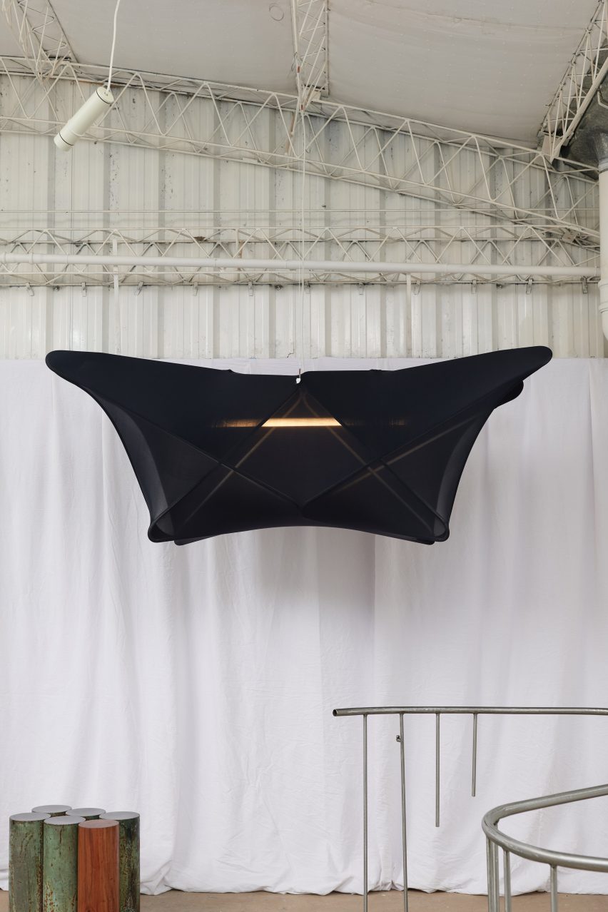 A hanging lamp covered in black fabric