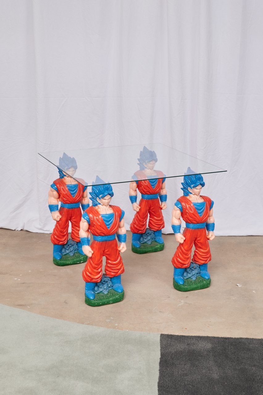 A glass tabletop place on the tip of the hair of four saiyans