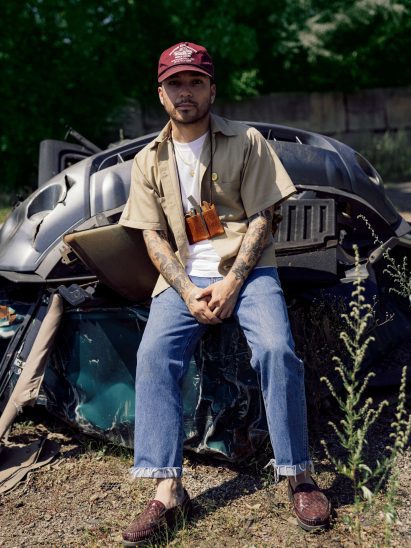 Noel Mercado on hood of junk car