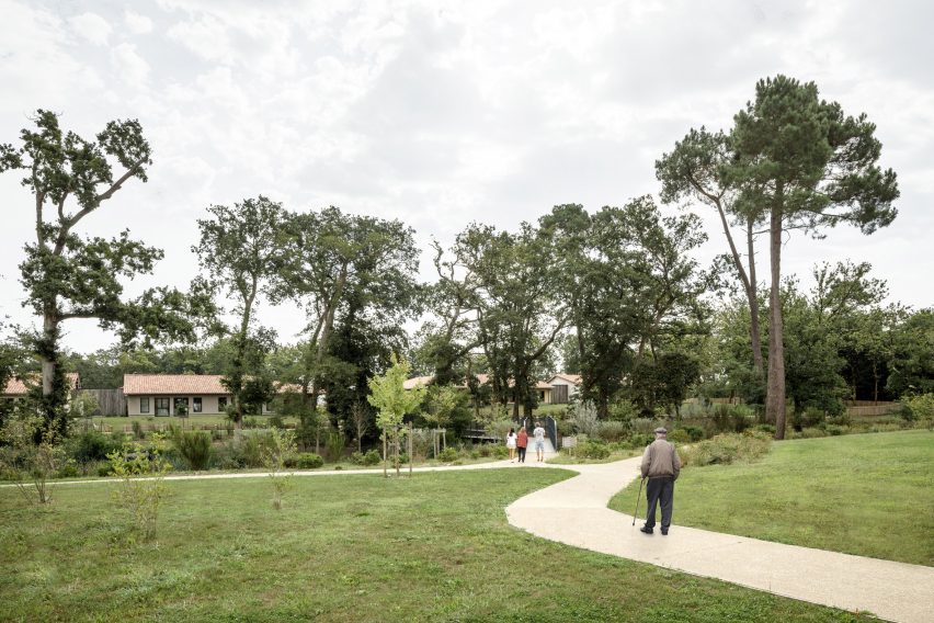 Garden path leading to the Alzheimer's Village in France by NORD Architects