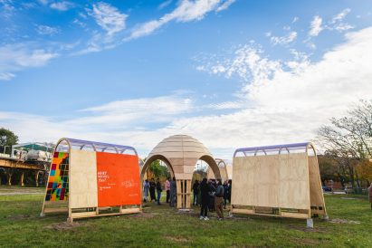 Wooden pavilion with train in the background