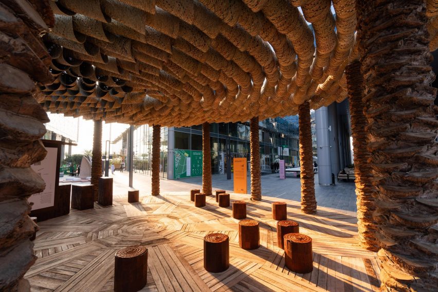 Palm tree trunks hold up the Of Palm pavilion