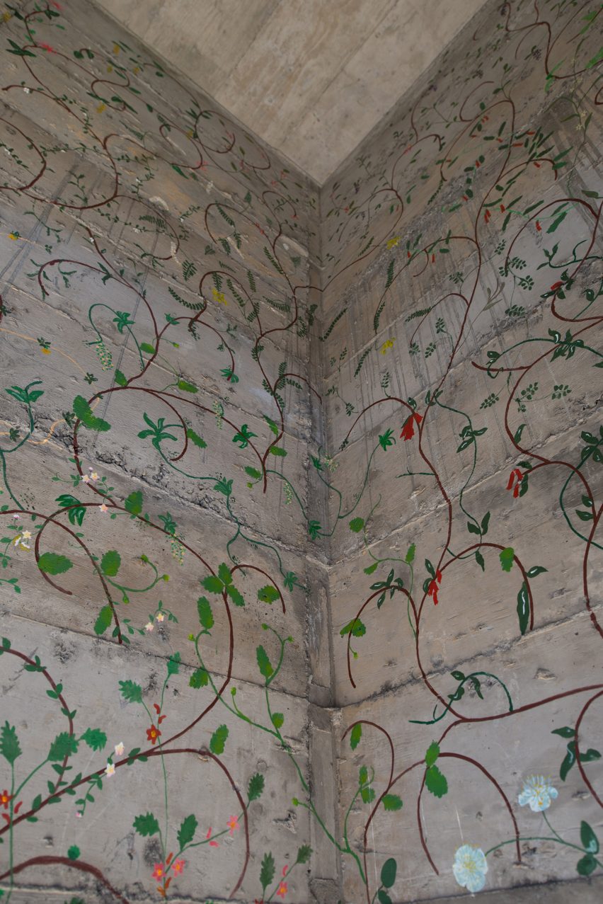 Flowers painted on concrete walls inside stairwell