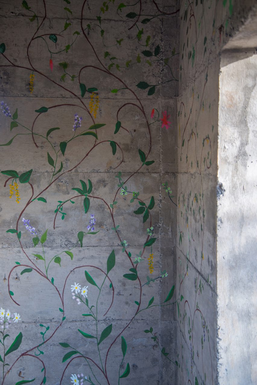 Flowers painted on concrete walls inside stairwell