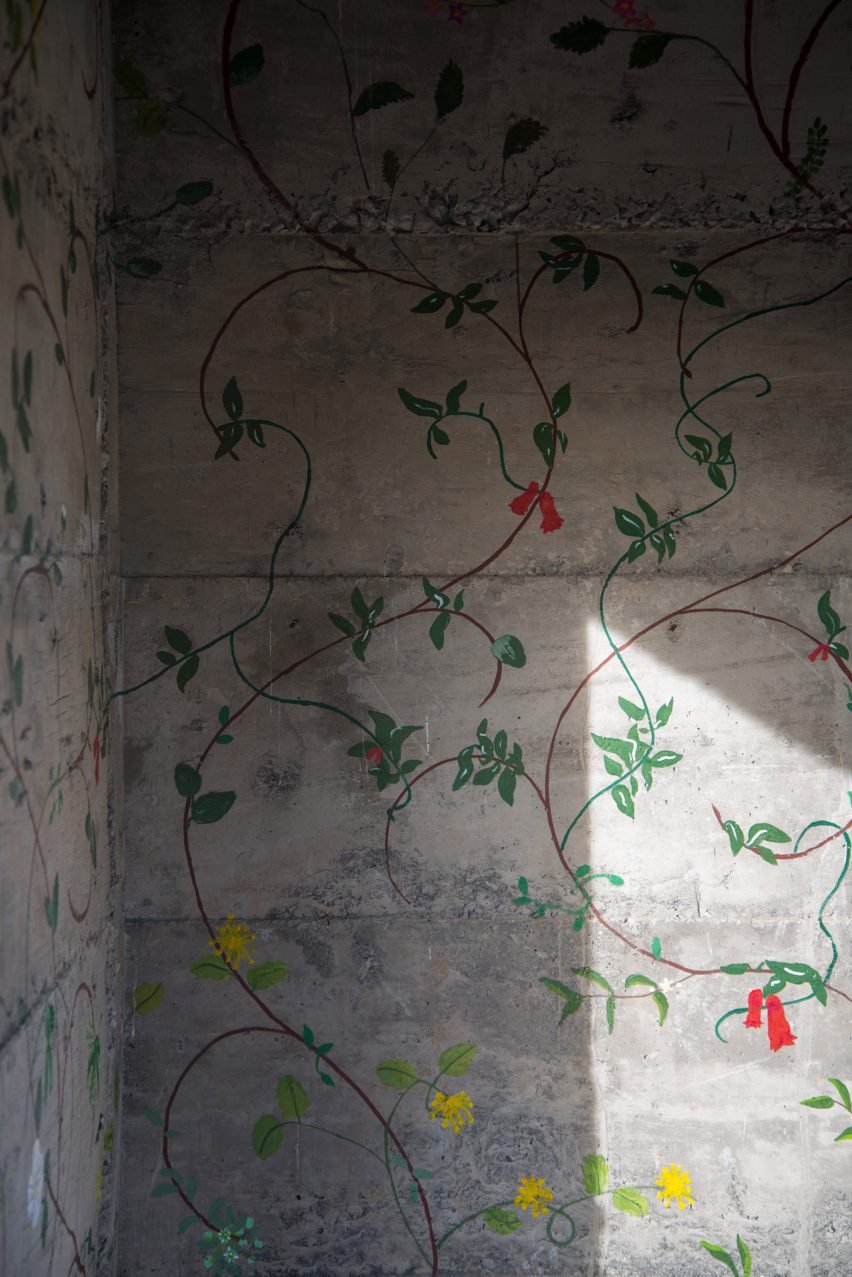 Flowers painted on concrete walls inside stairwell