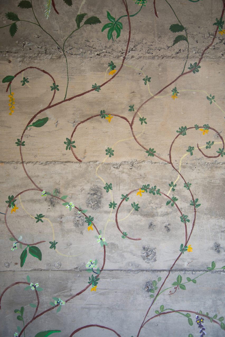 Flowers painted on concrete walls inside stairwell