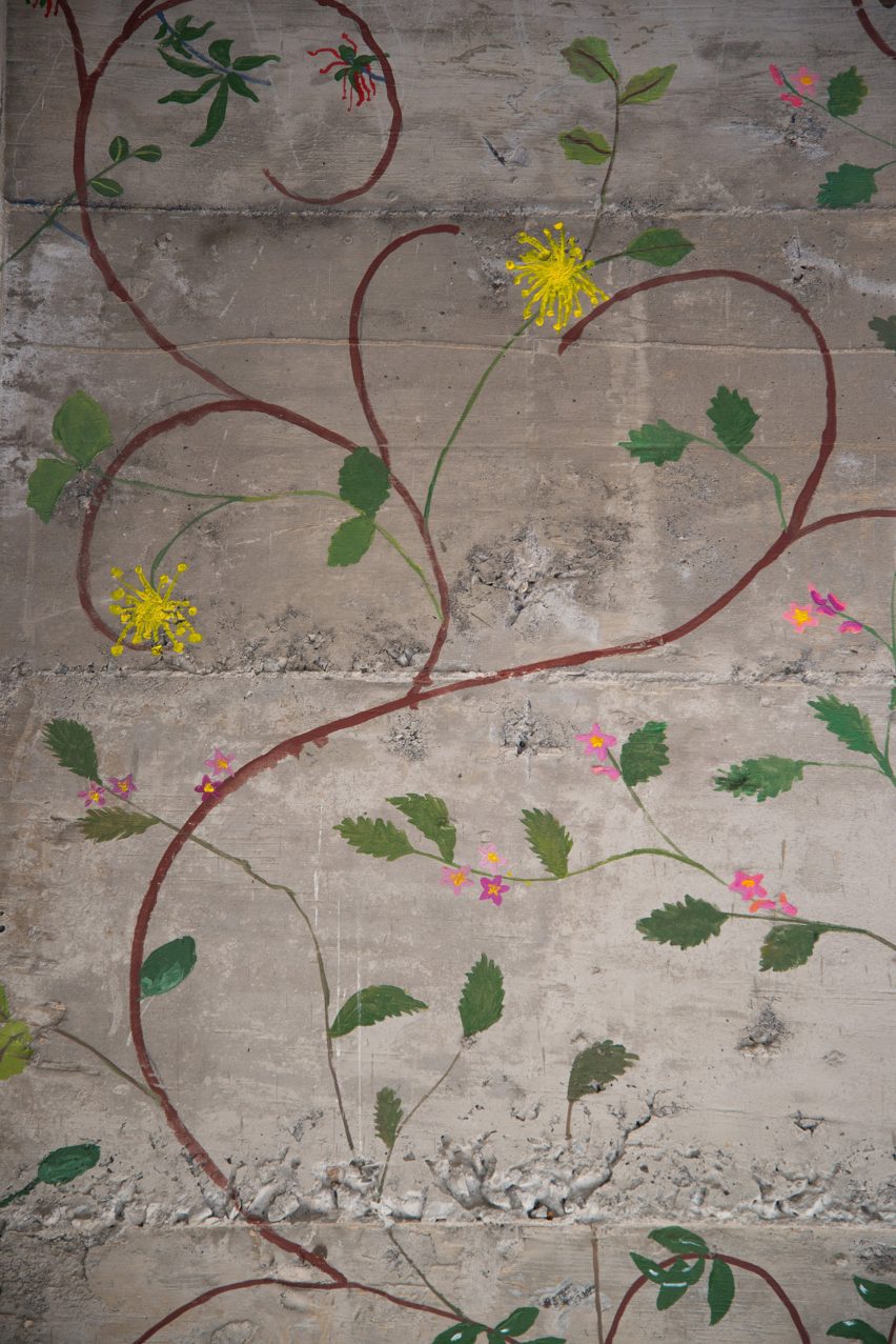 Flowers painted on concrete walls inside stairwell