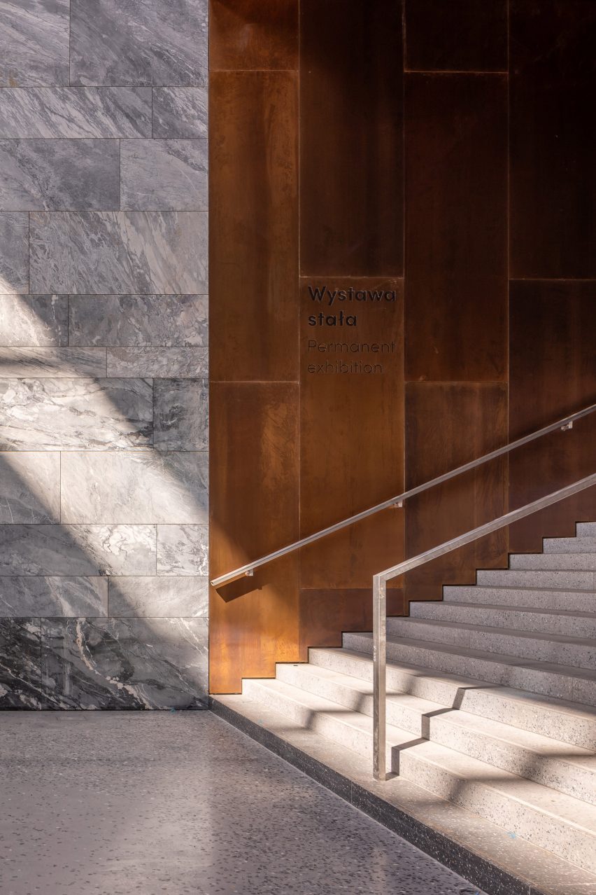 Public staircase with timber and grey marble walls