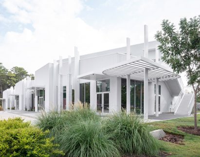 A white exterior with vertical fins and trellis