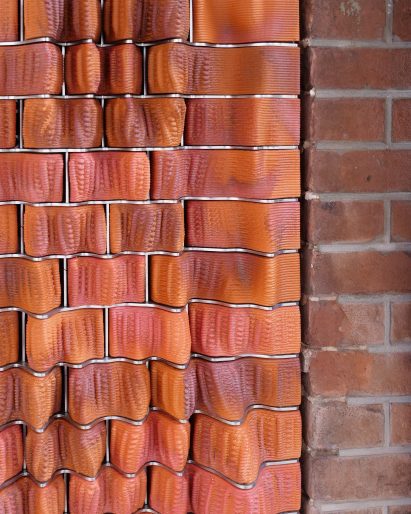 Close up detail of flush 3D printed ceramic tile facade by RAP Studio