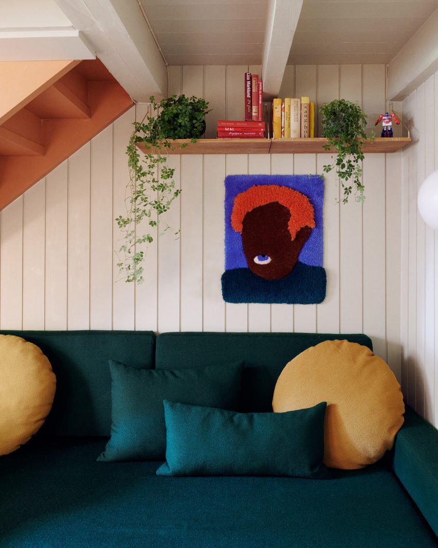 Green sofa under staircase
