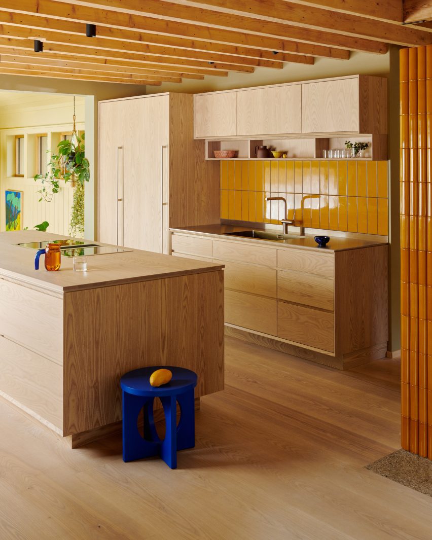 Kitchen with ask cabinets and yellow tile splashback