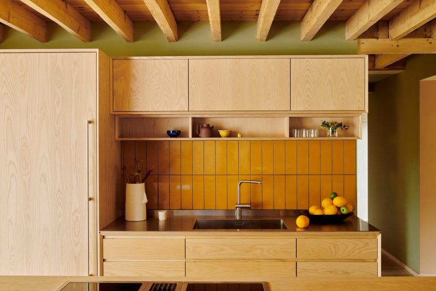 Kitchen with ask cabinets and yellow tile splashback