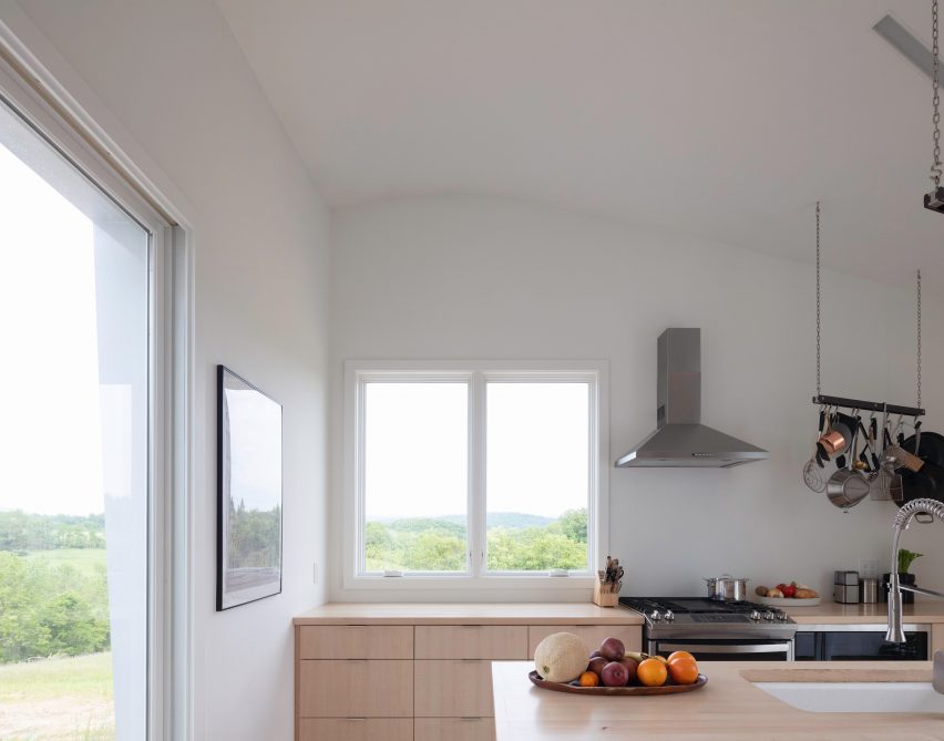 A kitchen with light cabintry