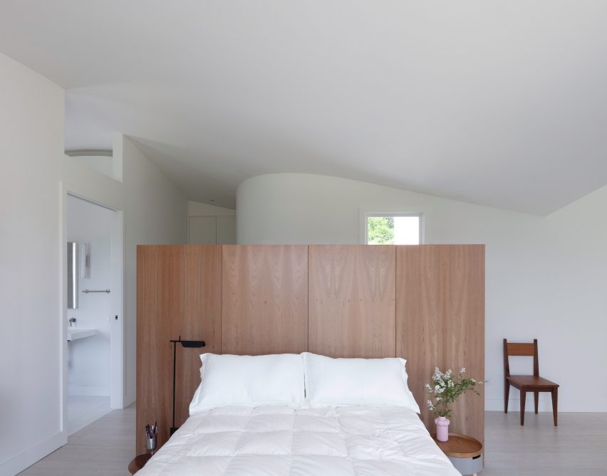 A wooden bed frame in the middle of a room