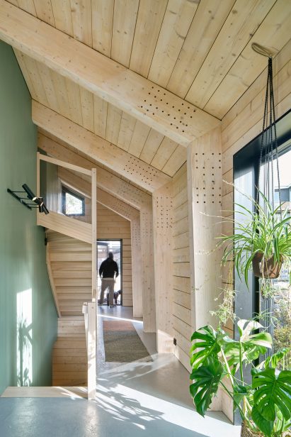 Mass-timber residence on hillside features wooden interior