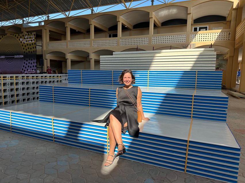 Exhibition designer Sofia Pia Belenky of Space Caviar sitting on materials used for the displays