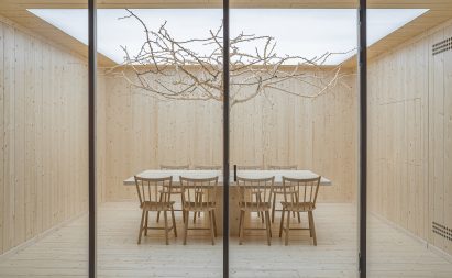 Meeting room with bare tree in car showroom