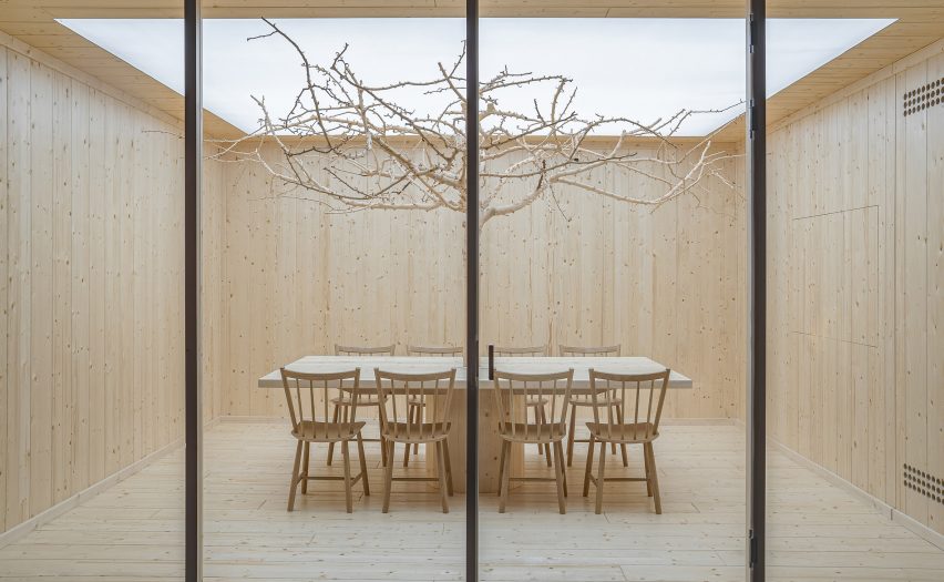 Meeting room with bare tree in car showroom