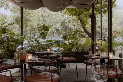 Covered outdoor patio surrounded by plants