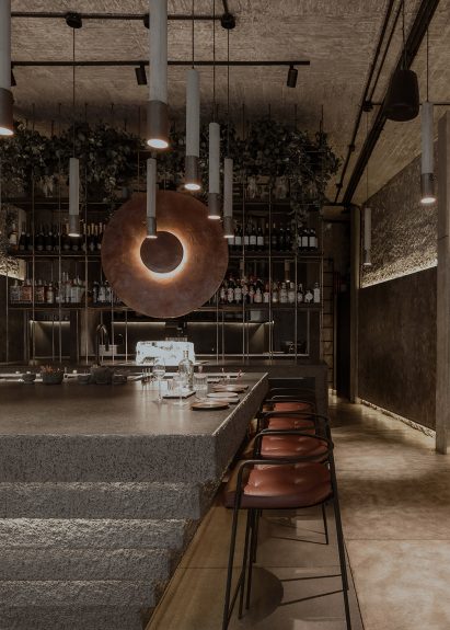 Inverted ziggurat bar with cove lighting along its tiered sides