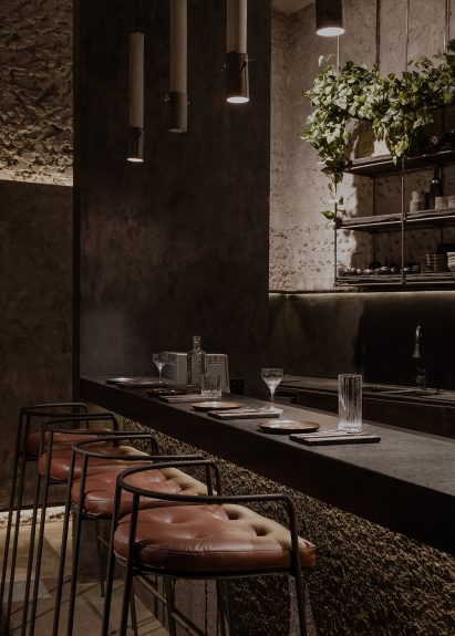 Slender-framed metal stools against a bar counter