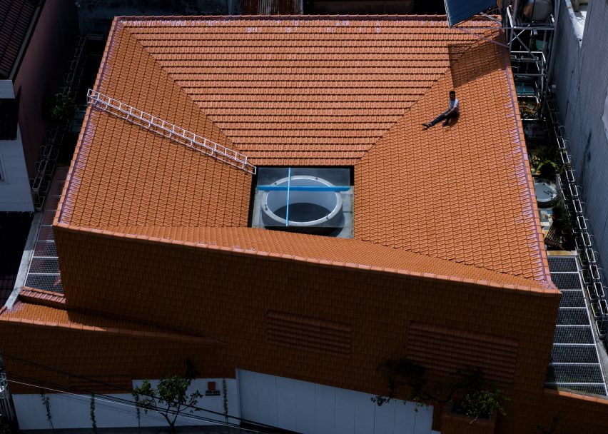 Sloping red-tiled roof with an oculus