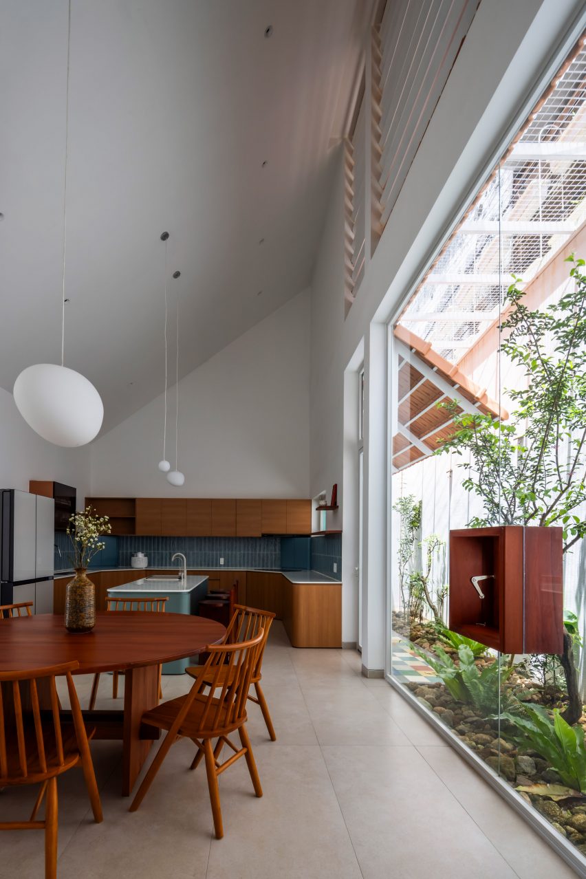 White dining room and kitchen with an outdoor courtyard