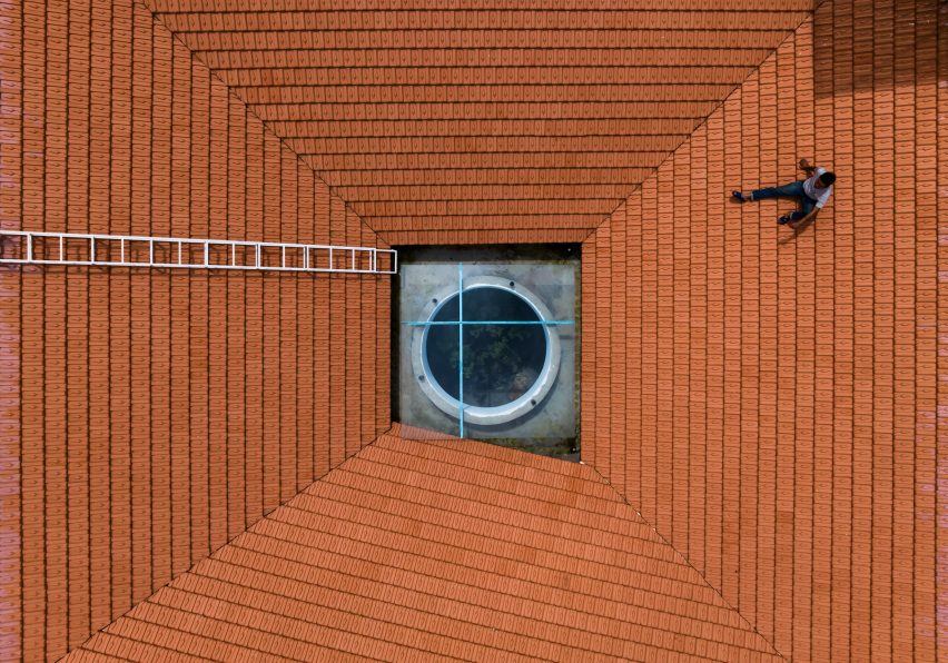 Sloping red-tiled roof with a circular skylight