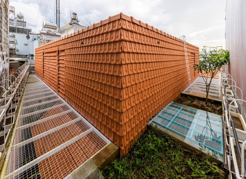 Red-tiled exterior walls at Tile House by The Bloom Architects