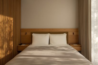 Minimalist neutral double bed within the Trunk Hotel in Tokyo