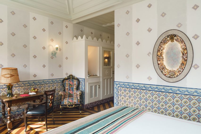 Shell mirror on patterned wallpaper