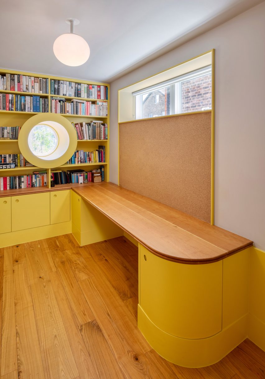 Yellow library and study space with round porthole window