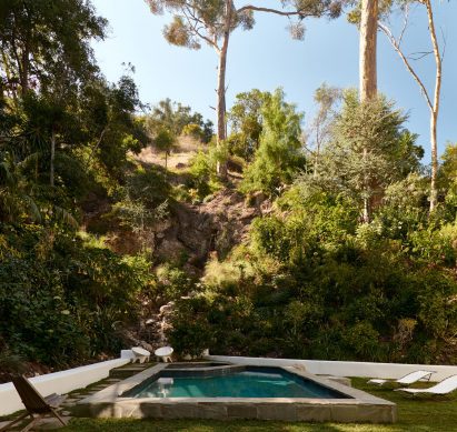 Garden featuring a swimming pool and a 40-foot (12-metre) waterfall