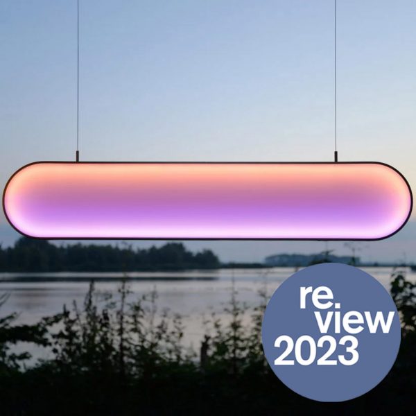 Pink and orange light hanging in front of lake view