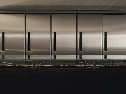 Close-up of the steel, glass-topped table
