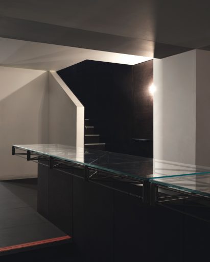 Glass-topped central table in the basement