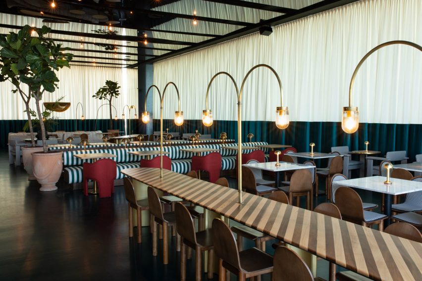 Striped awnings of Anfibio restaurant by Bacana Studio