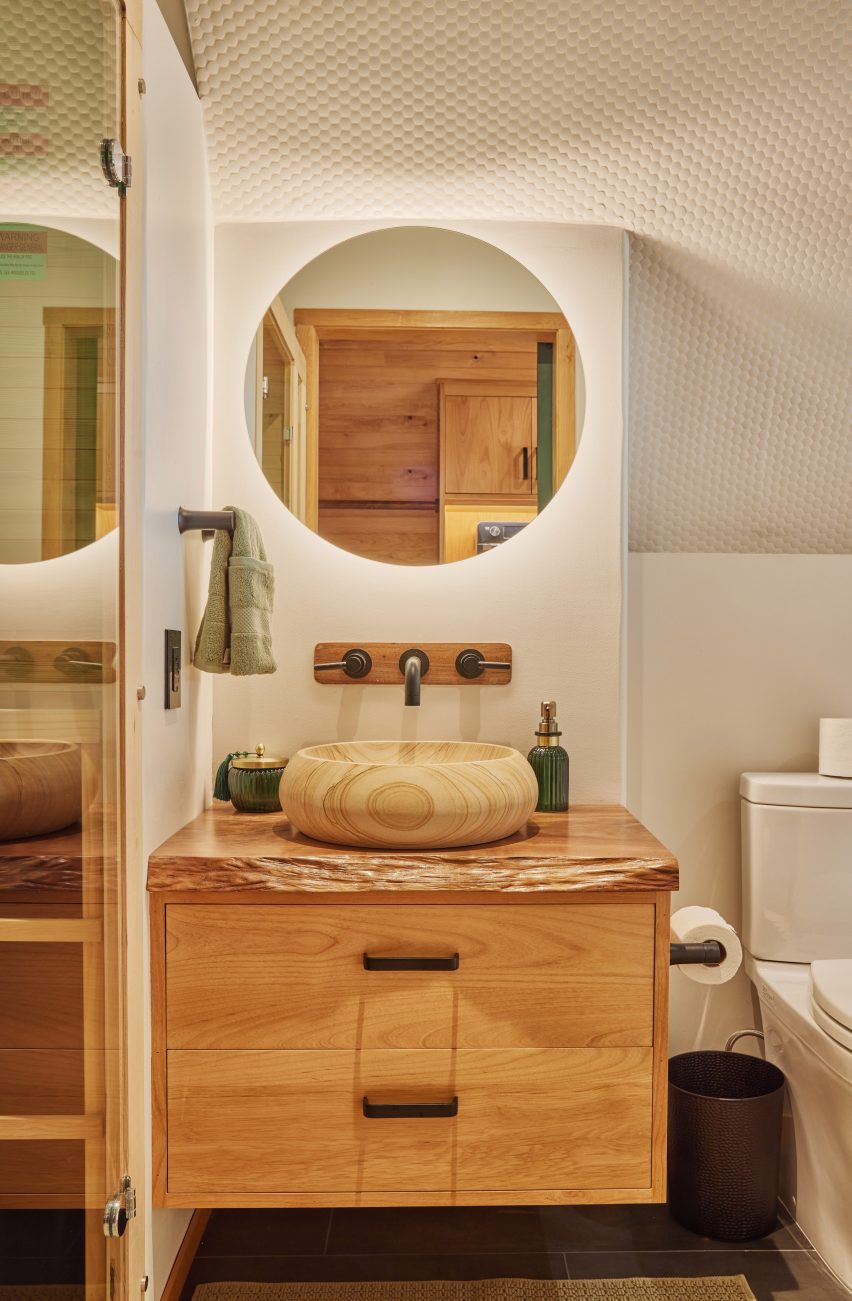 A bathroom with wooden vanity
