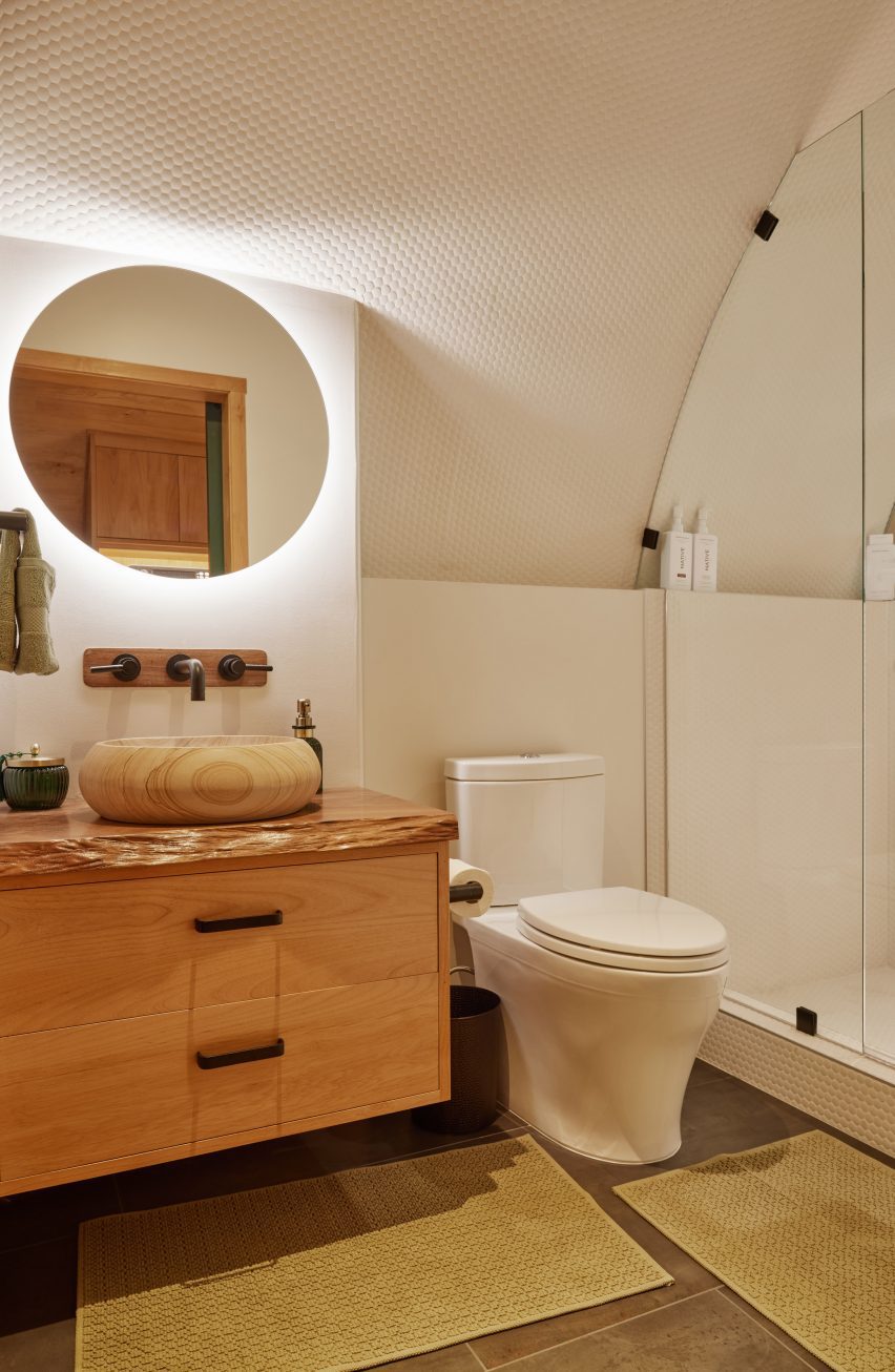 A white bathroom with wooden vanity