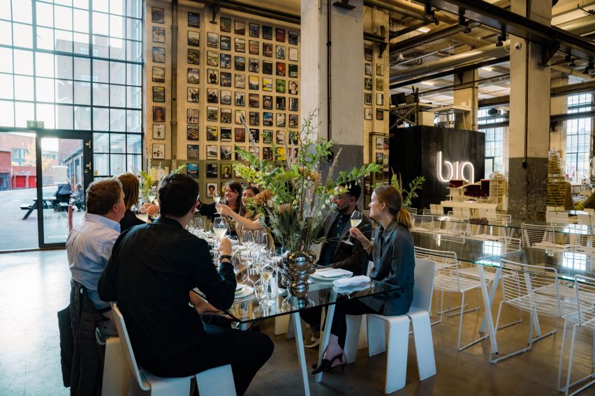 Photo of a big group of people having lunch and sharing a toast at BIG's studio