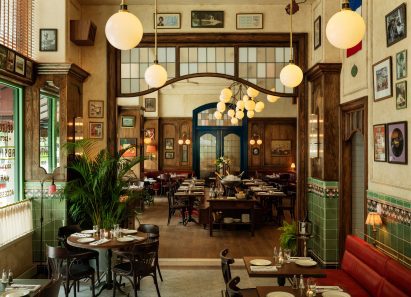 Le Suprême brasserie interior with green tiles and wood accents