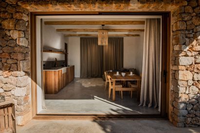 View through large opening into a neutral-toned interior